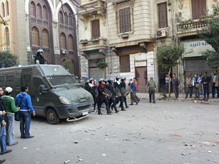 Egypt riot police, 22-11-2011. A massive contingent of at least 100 riot police marching up Mohamed Mahmoud Street. Source: http://www.flickr.com/photos/aljazeeraenglish/6382825635/